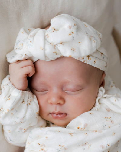 MUSLIN HEADBAND - BØRN BABY - sleeping baby wearing Jamie Kay organic knotted bow headband in print nina watercolour floral